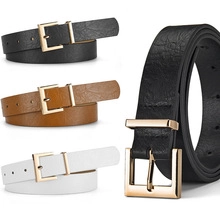 Detailed view of leather belts in black, brown and white with golden square buckles
