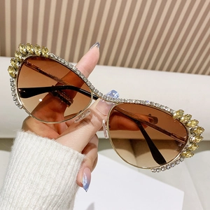 Luxe oversized cat-eye sunglasses with gold metal frame and sparkling rhinestone crystals