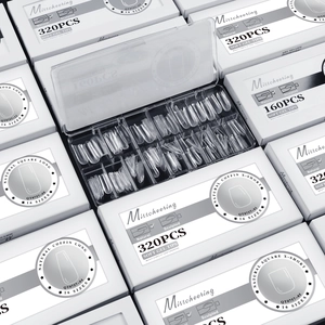 Macro view of transparent soft gel nail tips in various shapes and 16 sizes in a box