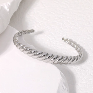 Twisted silver titanium steel open bangle with a minimalist croissant style design