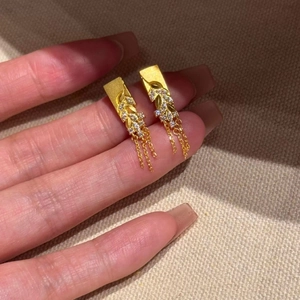 Gold-plated wheat ear tassel earrings with zircons shown on a neutral fabric background