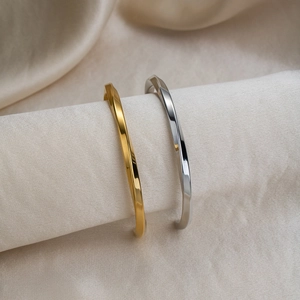 Minimalist twisted open cuff bracelets in polished gold and silver stainless steel