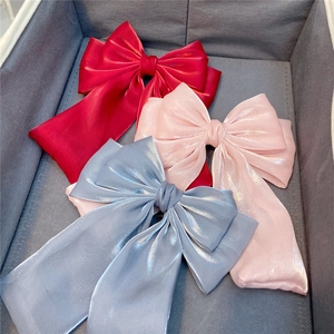 Three-layer satin bow hair clips with long ribbons in red, pink, and blue colors