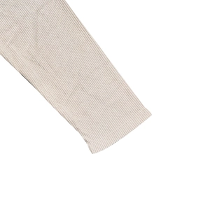Detailed close-up of beige ribbed knit cuffs on a men's corduroy baseball collar shirt