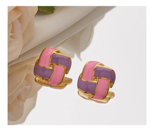 Macro detail of pink and purple enamel square earrings with a woven gold metal texture