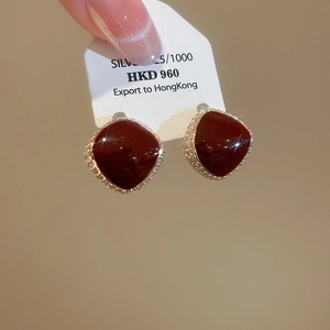 Macro shot of vintage red square stud earrings with silver 925 base and zircon halo