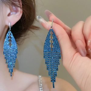 Close-up of royal blue rhinestone tassel earrings featuring elegant fringe drop detail