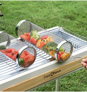 Macro detail of rolling stainless steel BBQ mesh basket for grilling vegetables outdoors