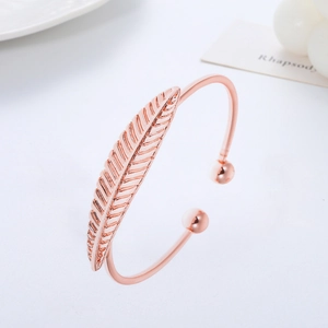 Rose gold adjustable cuff bracelet featuring detailed feather design and polished metal beads