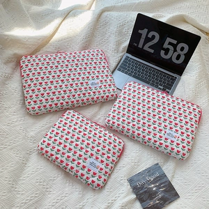 Detailed comparison of quilted cotton laptop sleeves in different sizes with tulip patterns