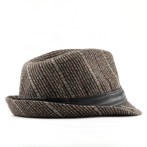 Detail of vintage striped brown fedora hat featuring a black faux leather decorative band