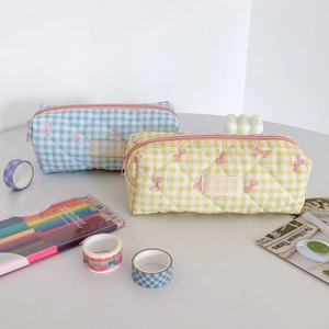 Detailed view of quilted cotton checkered pencil cases with cute pink bow patterns