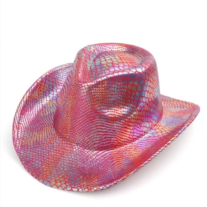 Detail of red-pink iridescent snakeskin texture on a western cowboy party hat