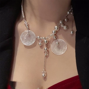 Elegant pearl and shell tassel necklace for women featuring a retro asymmetrical design
