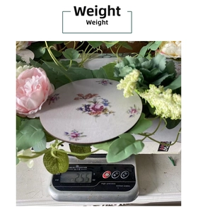Detail shot showing 255g weight of a ceramic floral coaster with pink flower patterns