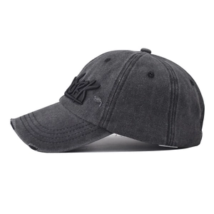 Detailed close-up of vintage washed denim baseball cap with New York embroidery