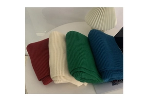 Close-up of thick ribbed knit scarves in burgundy, beige, green and navy blue colors