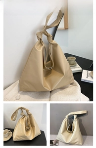 Detailed view of khaki large capacity tote bag with soft leather and knot shoulder strap