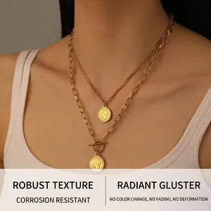 Close-up of double-layered gold-plated stainless steel coin necklace with OT toggle clasp