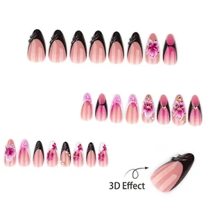 Faux ongles French noirs en amande avec fleurs 3D, perles et strass scintillants