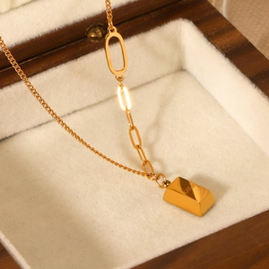 18K gold plated brick pendant necklace in stainless steel on a wooden jewelry display box