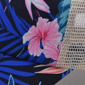 Macro detail of floral hibiscus print and breathable beige mesh on ponytail baseball cap