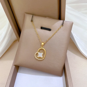 Elegant gold titanium necklace featuring a heart pendant with crystals and white star inlay