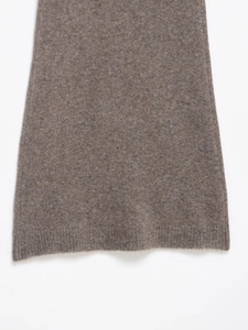 Detailed macro view of high-quality brown knit fabric texture and bottom hem of the mini dress