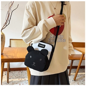 Detail of cute bear-shaped contrast canvas crossbody bag with FASHION label