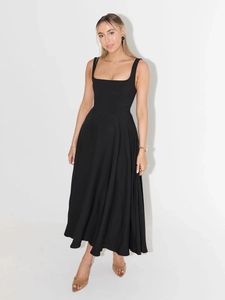 Macro detail of elegant black square neck dress with sleeveless cut and high waist