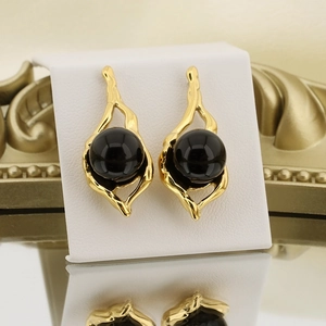 French retro gold geometric stainless steel earrings featuring a large black round bead