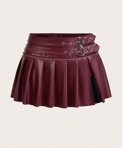 Detail of burgundy PU leather pleated skirt featuring side slit and double metal buckles