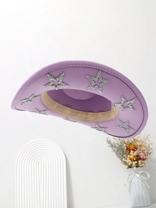 Detail of purple felt cowboy hat with silver glitter stars and minimalist props