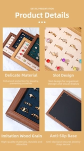 Detail presentation of walnut wood jewelry tray with soft velvet slots and non-slip base