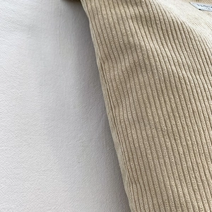 Macro shot of high-quality beige corduroy texture and Fashion tag on a large canvas bag