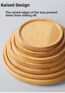 Detailed view of stacked round bamboo trays with raised edges and natural wood grain finish