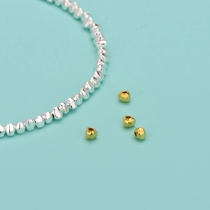 S925 sterling silver beads with heart-shaped gold accents on turquoise background
