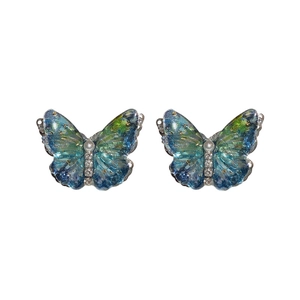 Blue-green butterfly earrings with zircon, pearls, and silver pins on white background