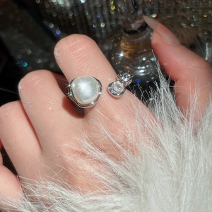 Close-up of a vintage pearl ring with sparkling zircon and cat ear accents