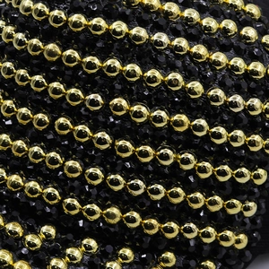 Macro view of gold metal beads and black rhinestones on a stylish baseball cap