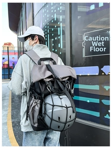 Close-up of tactical backpack with elastic mesh net securing a cycling helmet
