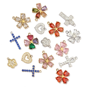 Collection of zircon clover heart and cross charms in gold and silver plating