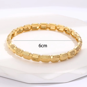 Detail showing the 6cm diameter measurements of the gold-plated geometric bracelet