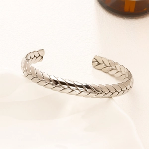 Polished silver titanium steel wheat-pattern open cuff bracelet on white tray