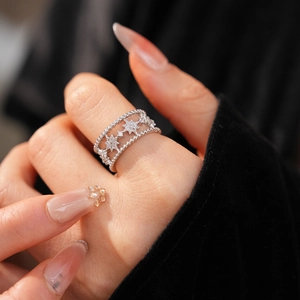 Close-up of a double-layered star ring with cubic zirconia and milgrain edge detailing