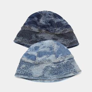 Close-up of washed denim bucket hats in dark and light blue with reinforced stitching detail