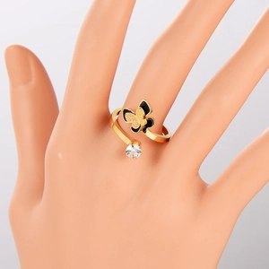Minimalist golden stainless steel butterfly ring with black oil drip and zircon on model