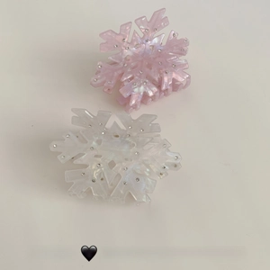 Close-up of elegant acetate snowflake hair claws with sparkling rhinestones set of two