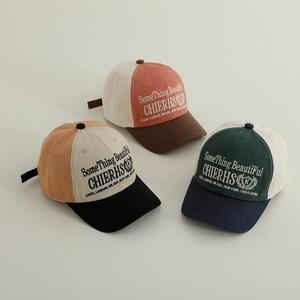 Three multi-color cotton baseball caps with embroidered lettering in a minimalist display