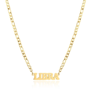 Detail of 18K gold stainless steel Libra zodiac necklace pendant on a white background